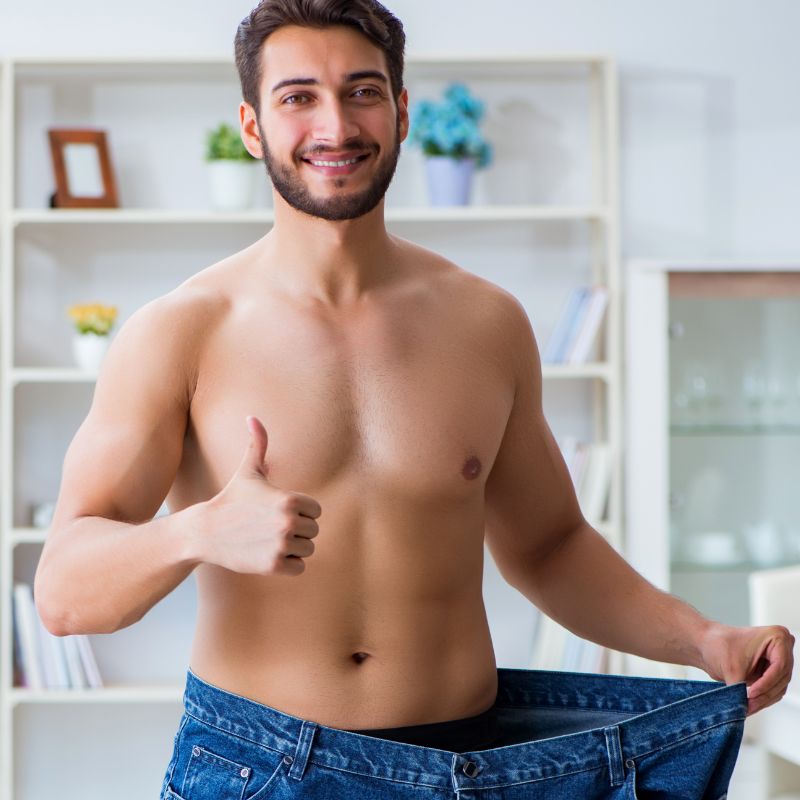 a man showing weight loss by pants that are too big